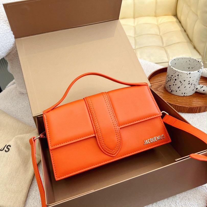 Orange Jacquemus handbag worn crossbody